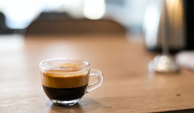 Shot of espresso in glass cup. ready for steamed milk to be added to create a cortado.