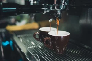 Espresso machine making 2 shots of espresso in cups.