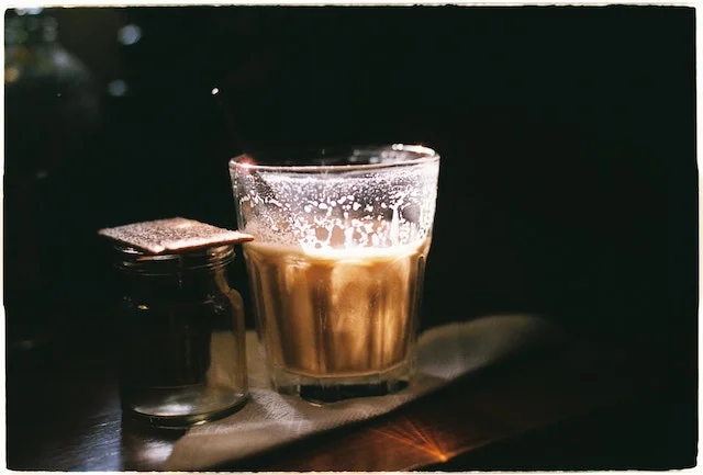 A glass of cafezinho on a table.