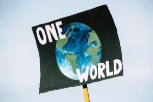 Placard of the world and text saying one world.